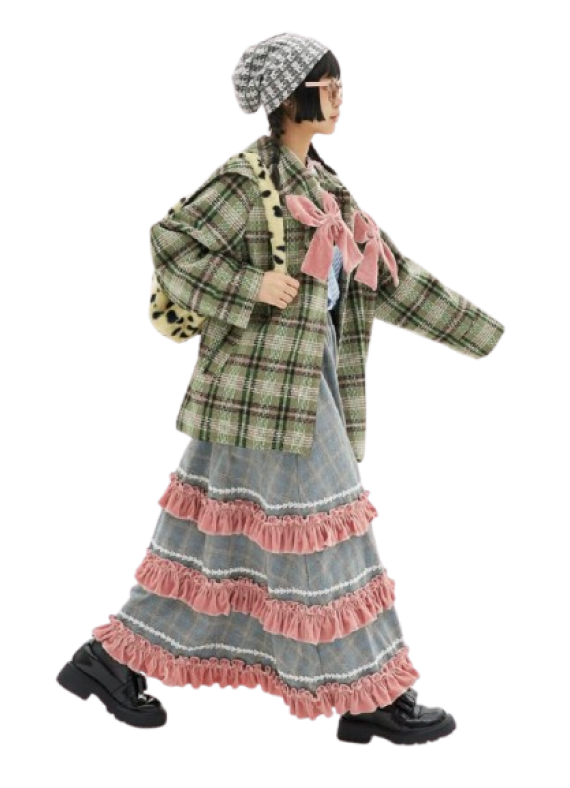 Girl wearing layered street style with plaid coat, ruffled denim skirt, and chunky shoes walking towards the right