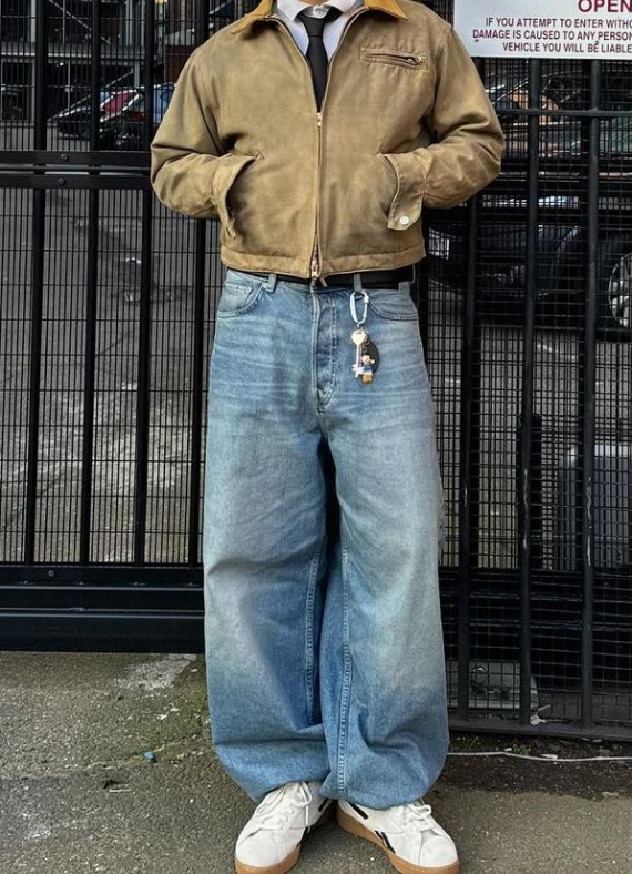 Vintage workwear meets modern street style with oversized denim, a cropped jacket, and classic sneakers.