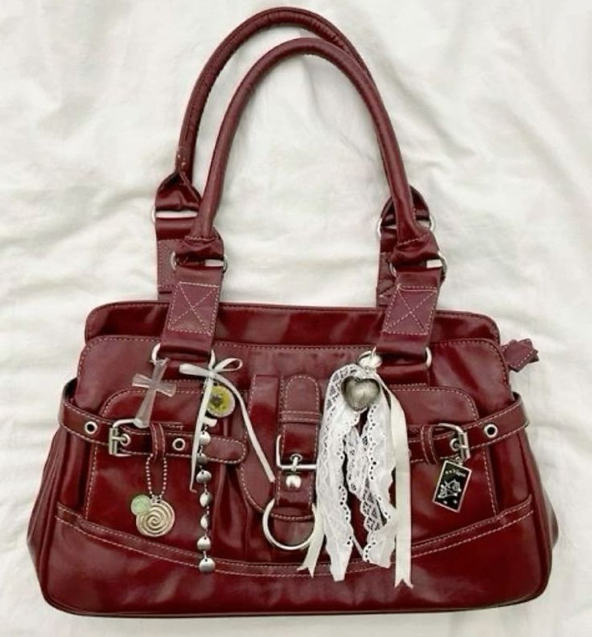 Vintage cherry red bag decorated with bows, buttons and charms