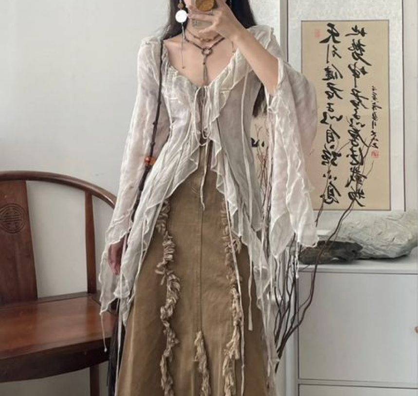 Flowy light beige top paired with sandy beige dress